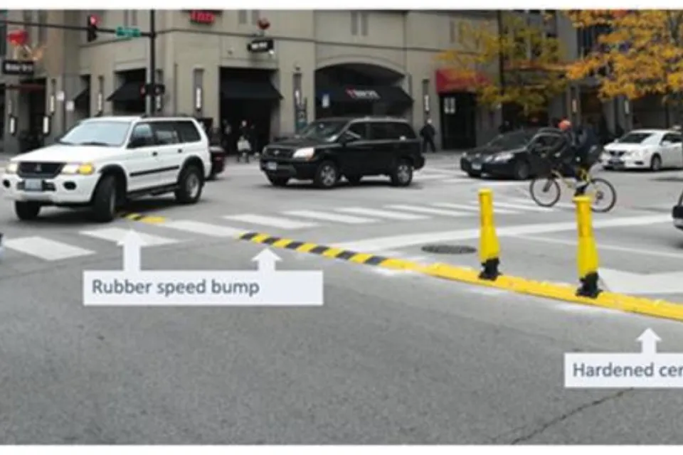 Crosswalk in Chicago with newly installed yellow delineators and speed bumps